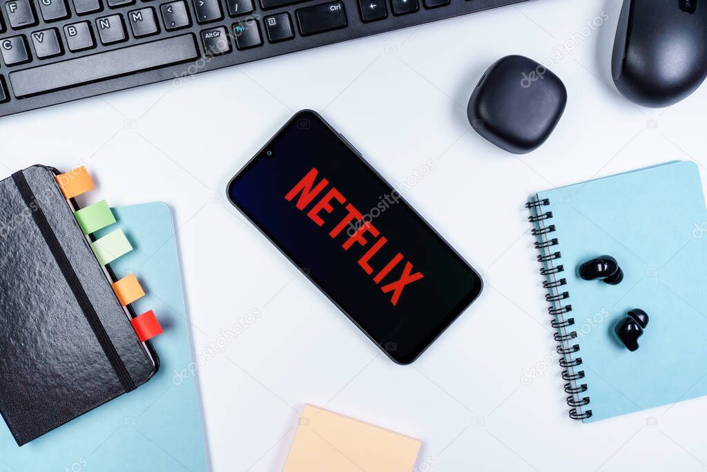 Prague, Czechia - 10 21 2024: Smartphone on surface showing Netflix logo.