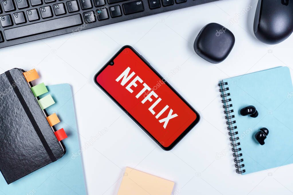 Prague, Czechia - 10 21 2024: Smartphone on surface showing Netflix logo.