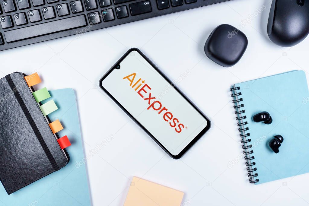 Prague, Czechia - 10 21 2024: Smartphone on surface showing AliExpress logo.