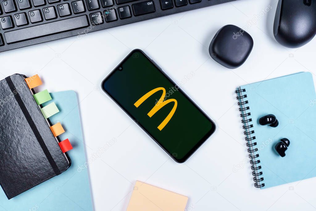 Prague, Czechia - 10 21 2024: Smartphone on surface showing McDonalds logo.