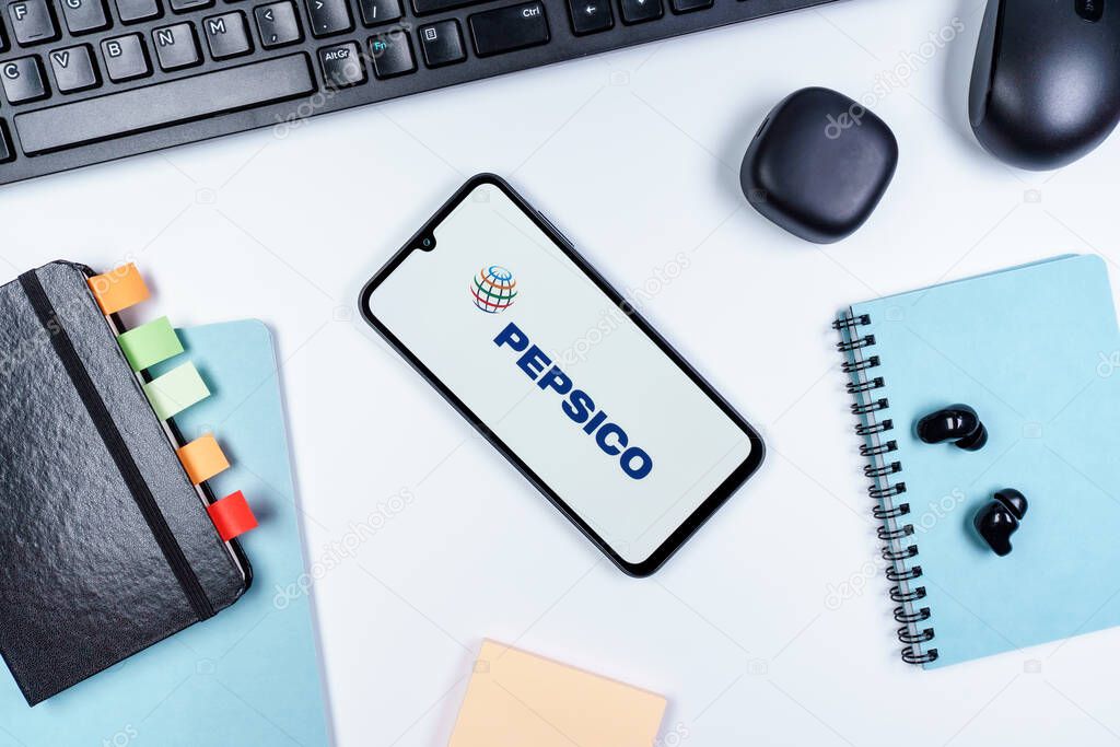 Prague, Czechia - 10 21 2024: Smartphone on surface showing Pepsico logo.