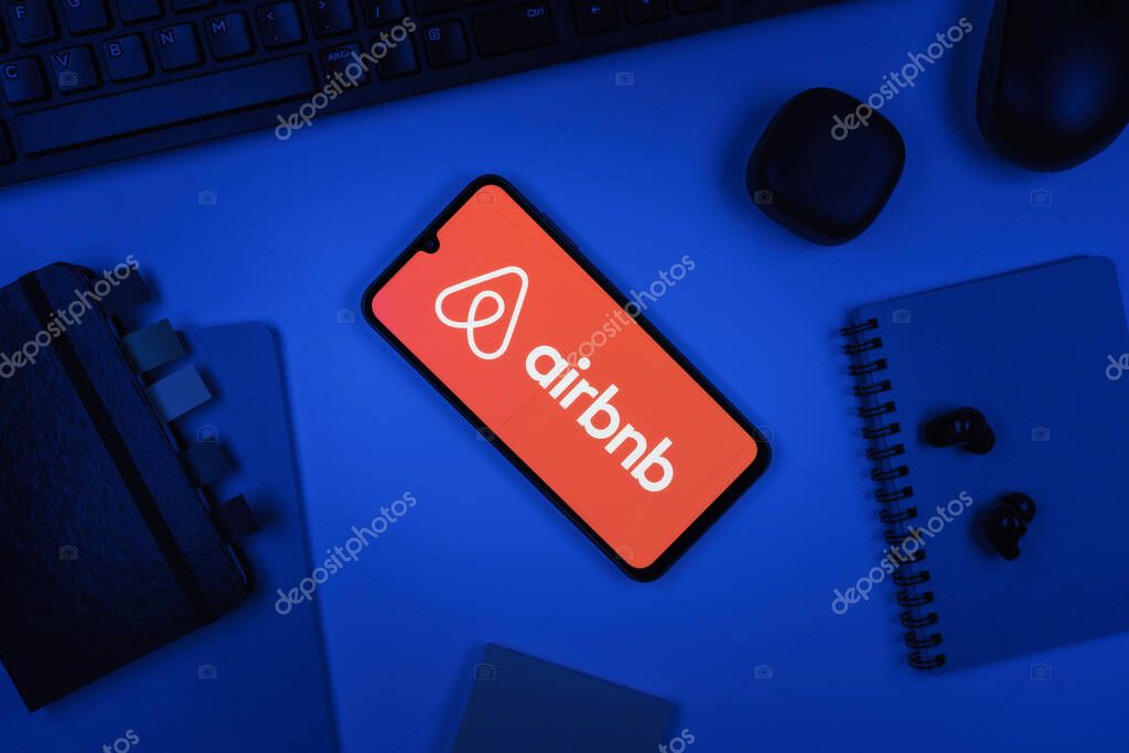 Prague, Czechia - 10 21 2024: Smartphone on surface showing Airbnb logo.