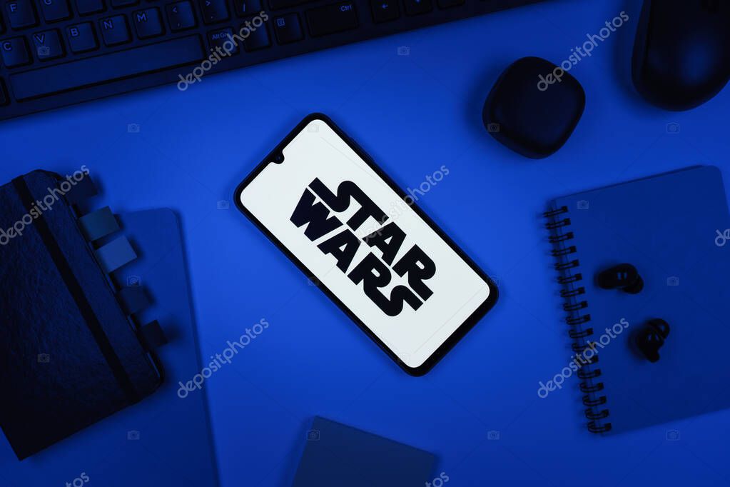 Prague, Czechia - 10 21 2024: Smartphone on surface showing Star Wars logo.