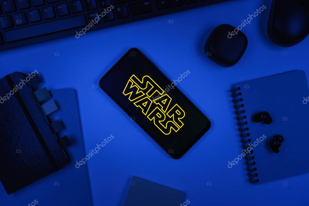 Prague, Czechia - 10 21 2024: Smartphone on surface showing Star Wars logo.