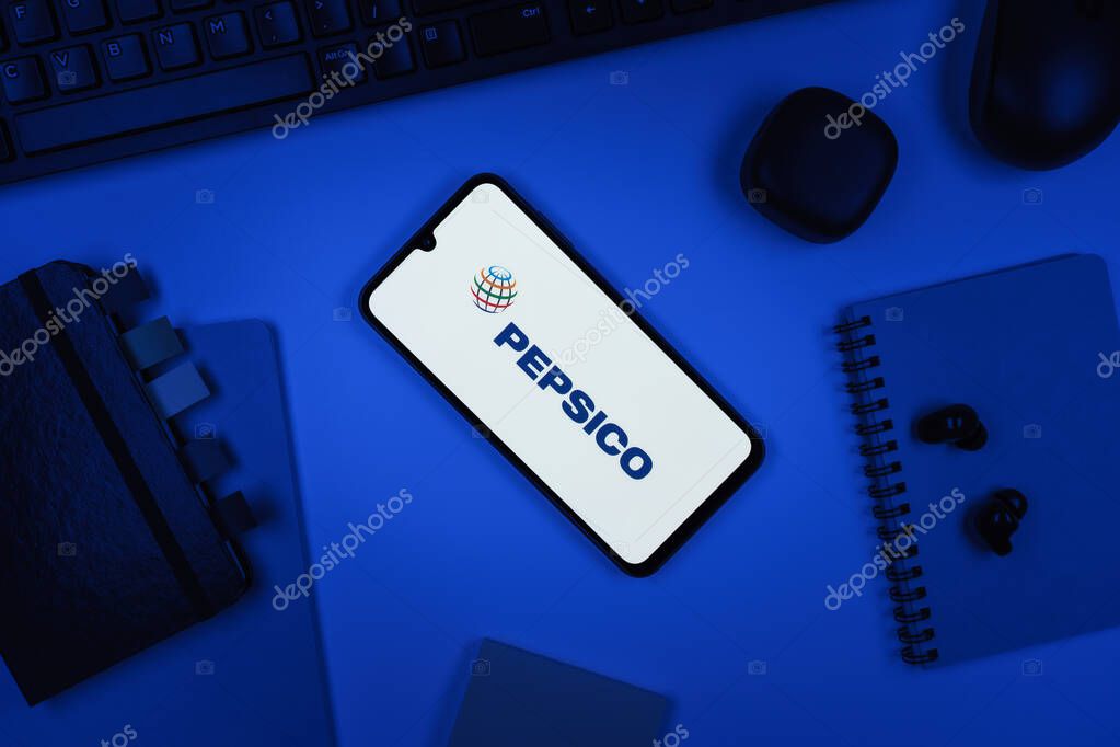 Prague, Czechia - 10 21 2024: Smartphone on surface showing Pepsico logo.