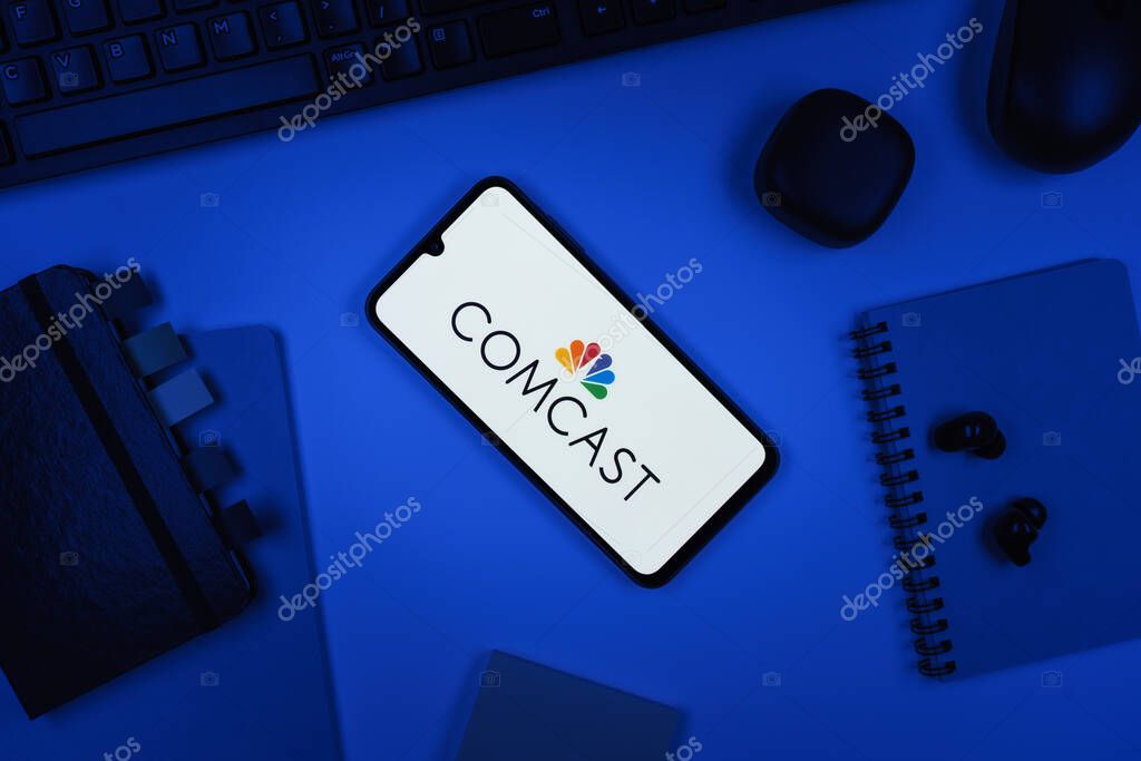 Prague, Czechia - 10 21 2024: Smartphone on surface showing Comcast logo.