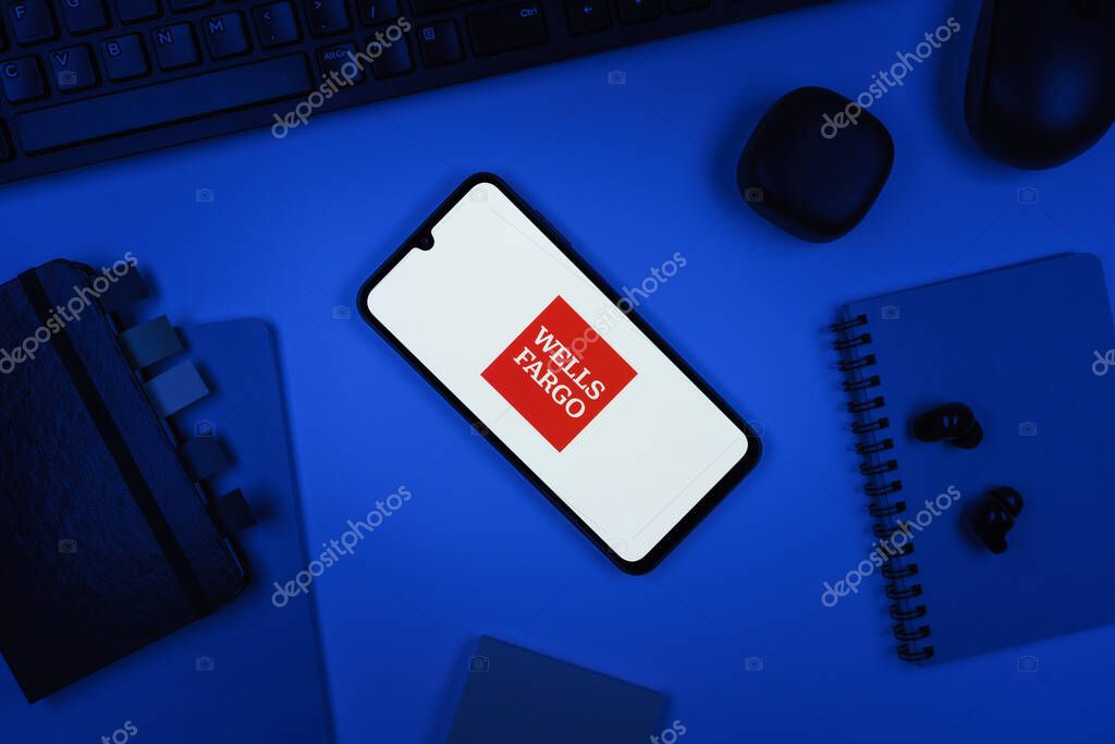 Prague, Czechia - 10 21 2024: Smartphone on surface showing Wells Fargo logo.