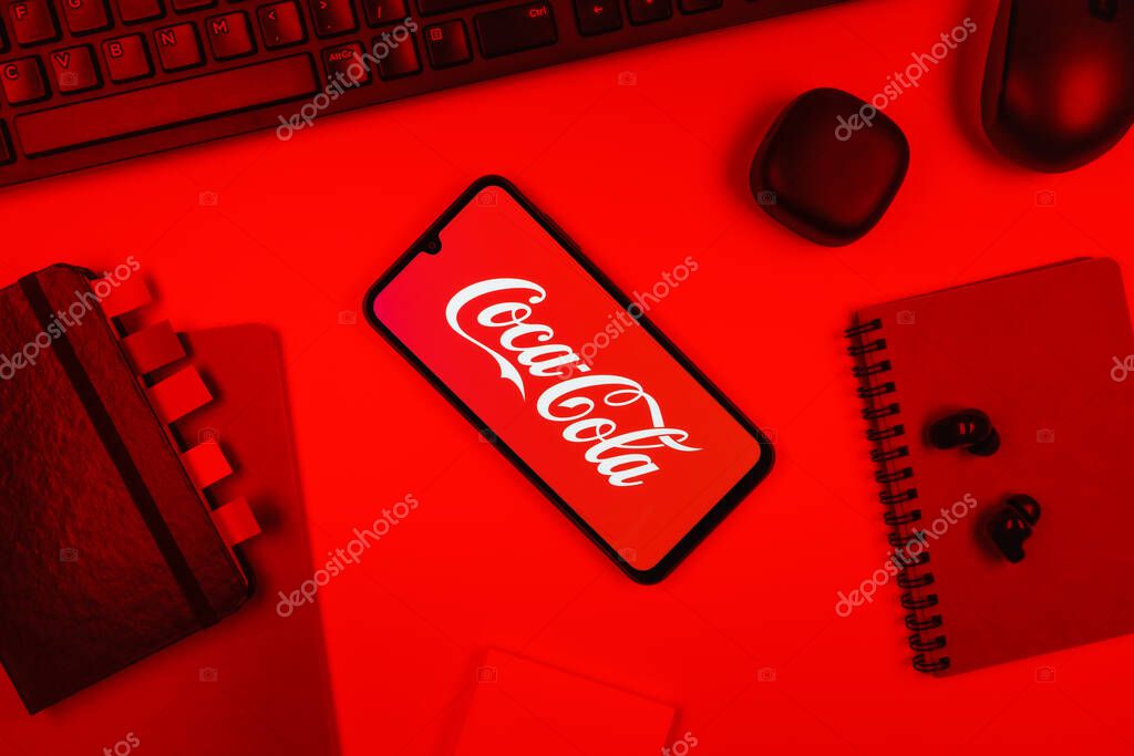 Prague, Czechia - 10 21 2024: Smartphone on surface showing Coca-Cola logo.