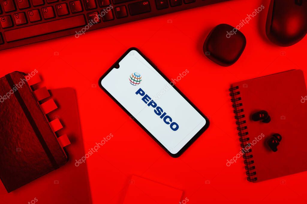 Prague, Czechia - 10 21 2024: Smartphone on surface showing Pepsico logo.