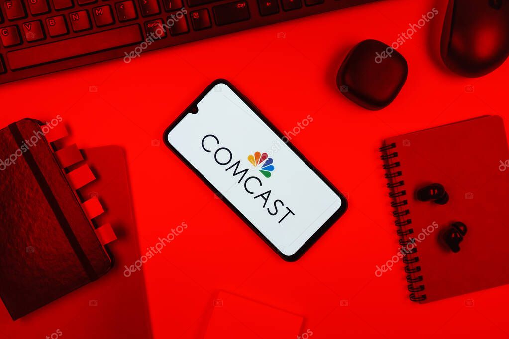 Prague, Czechia - 10 21 2024: Smartphone on surface showing Comcast logo.