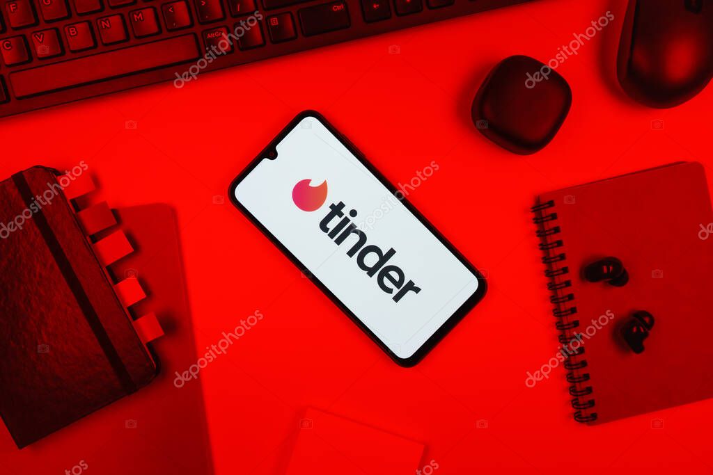 Prague, Czechia - 10 21 2024: Smartphone on surface showing Tinder logo.