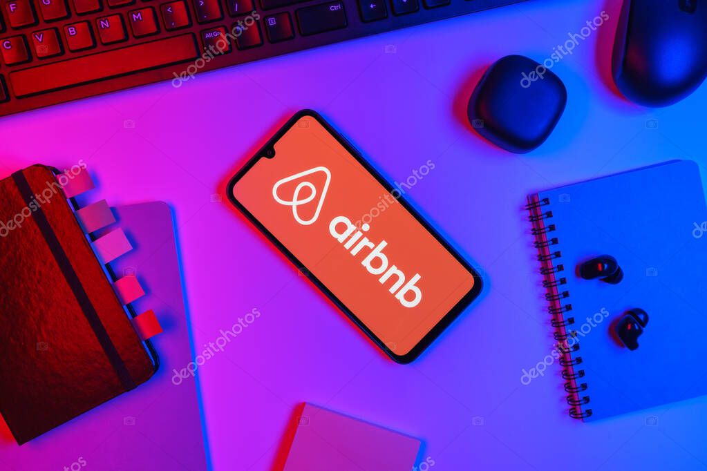 Prague, Czechia - 10 21 2024: Smartphone on surface showing Airbnb logo.