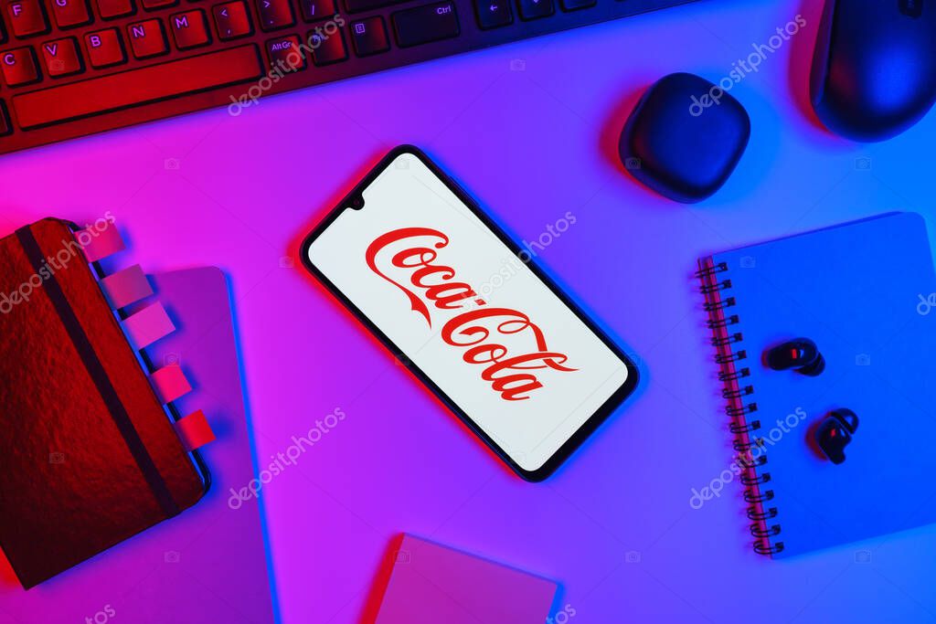 Prague, Czechia - 10 21 2024: Smartphone on surface showing Coca-Cola logo.