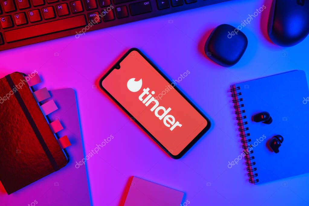 Prague, Czechia - 10 21 2024: Smartphone on surface showing Tinder logo.