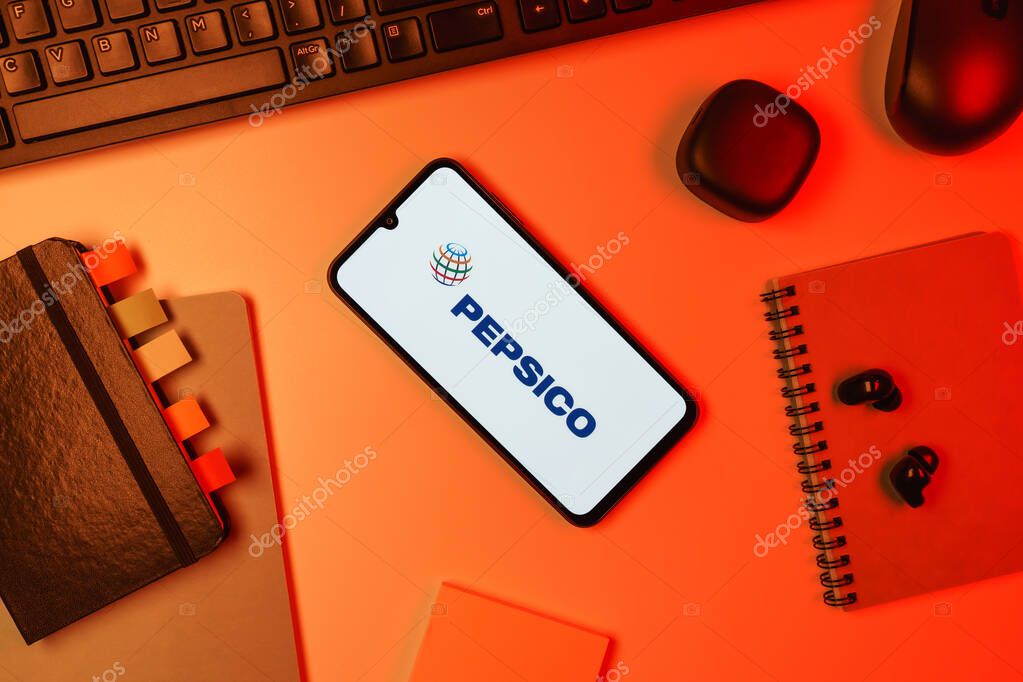 Prague, Czechia - 10 21 2024: Smartphone on surface showing Pepsico logo.