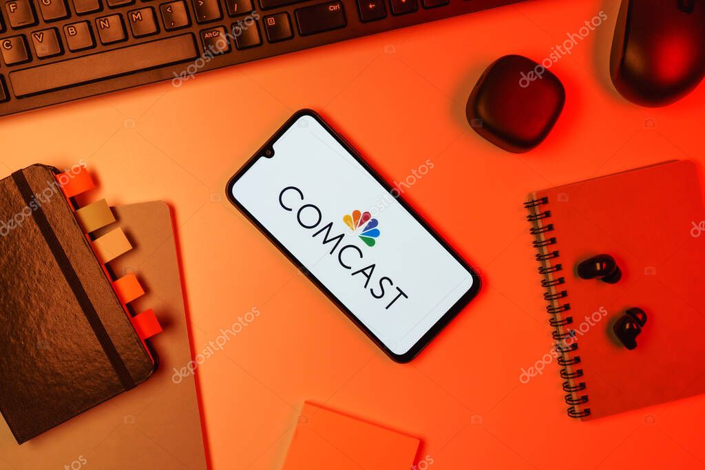 Prague, Czechia - 10 21 2024: Smartphone on surface showing Comcast logo.