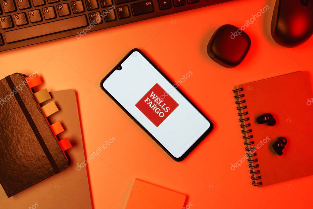 Prague, Czechia - 10 21 2024: Smartphone on surface showing Wells Fargo logo.