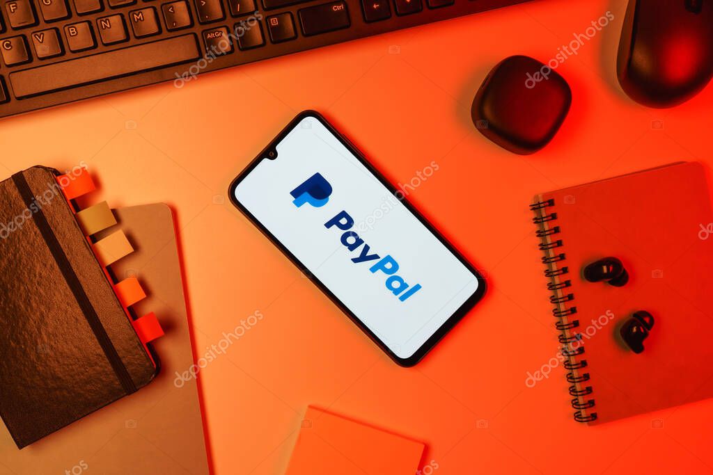 Prague, Czechia - 10 21 2024: Smartphone on surface showing PayPal logo.