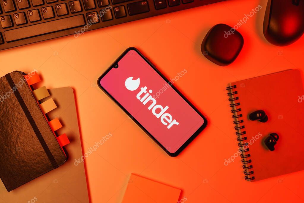 Prague, Czechia - 10 21 2024: Smartphone on surface showing Tinder logo.