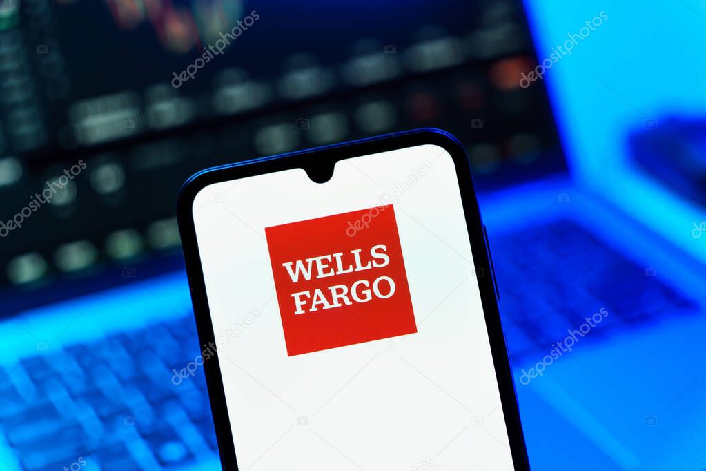 Prague, Czechia - 10 21 2024: Smartphone on surface showing Wells Fargo logo.