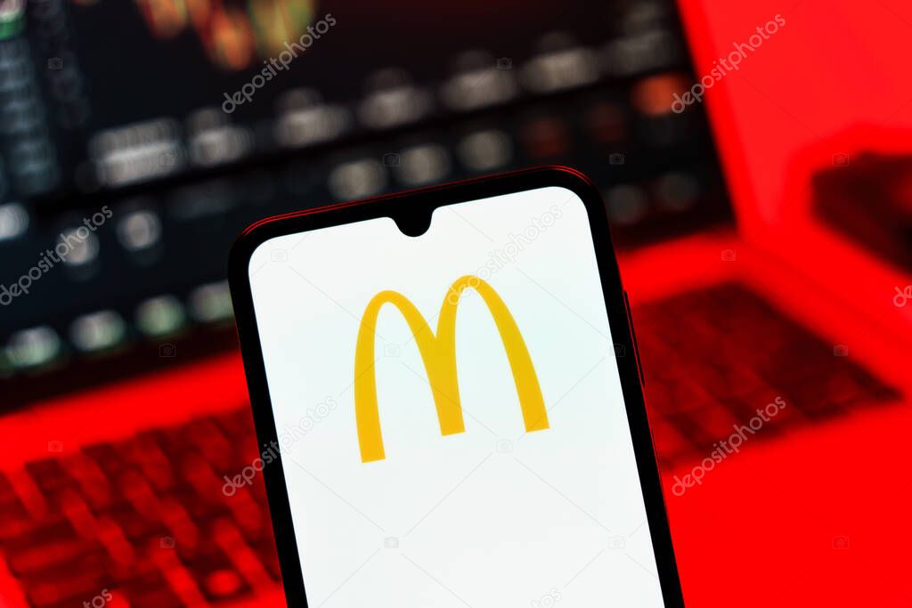 Prague, Czechia - 10 21 2024: Smartphone on surface showing McDonalds logo.