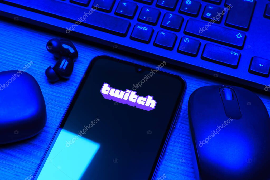 Prague, Czechia - 10 21 2024: Smartphone on surface showing Twitch logo.