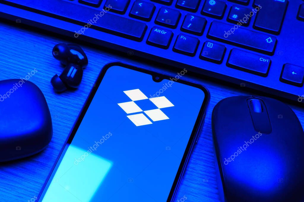 Prague, Czechia - 10 21 2024: Smartphone on surface showing Dropbox logo.