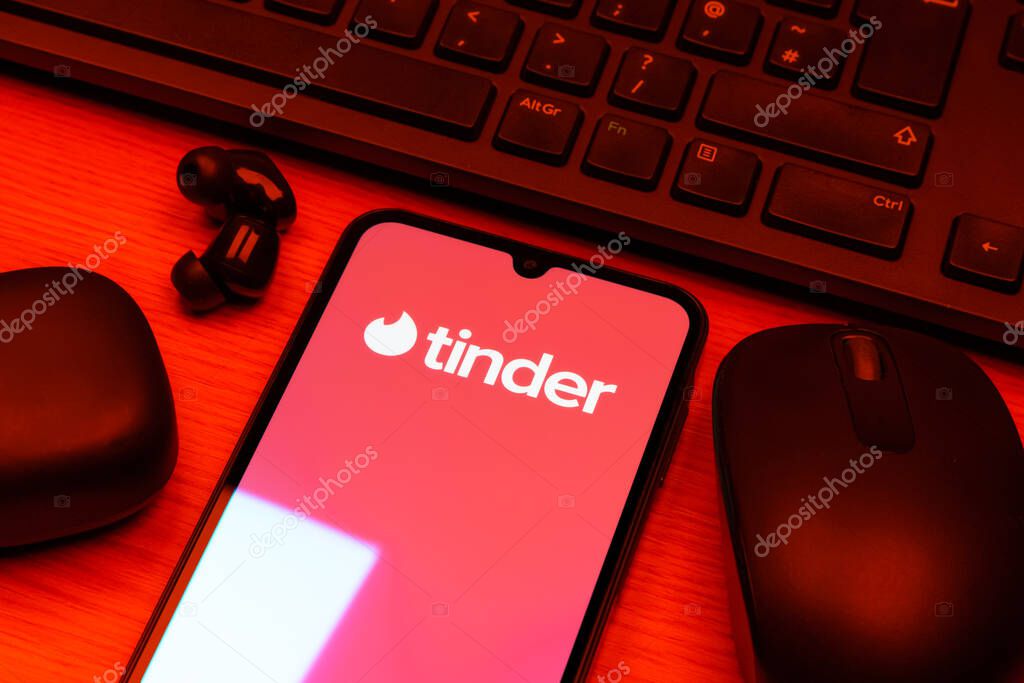Prague, Czechia - 10 21 2024: Smartphone on surface showing Tinder logo.