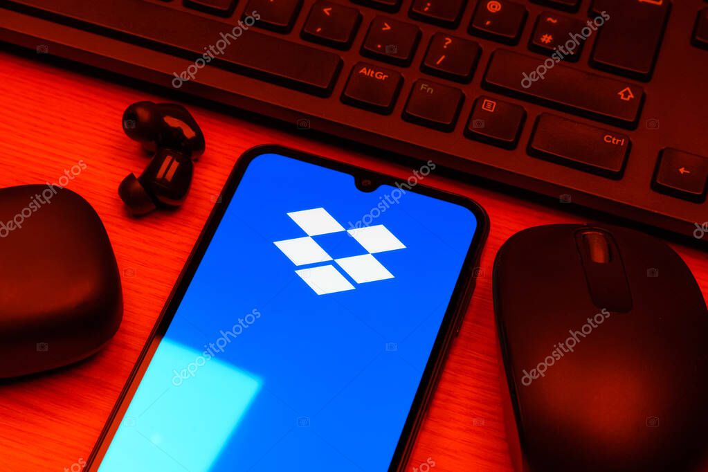 Prague, Czechia - 10 21 2024: Smartphone on surface showing Dropbox logo.