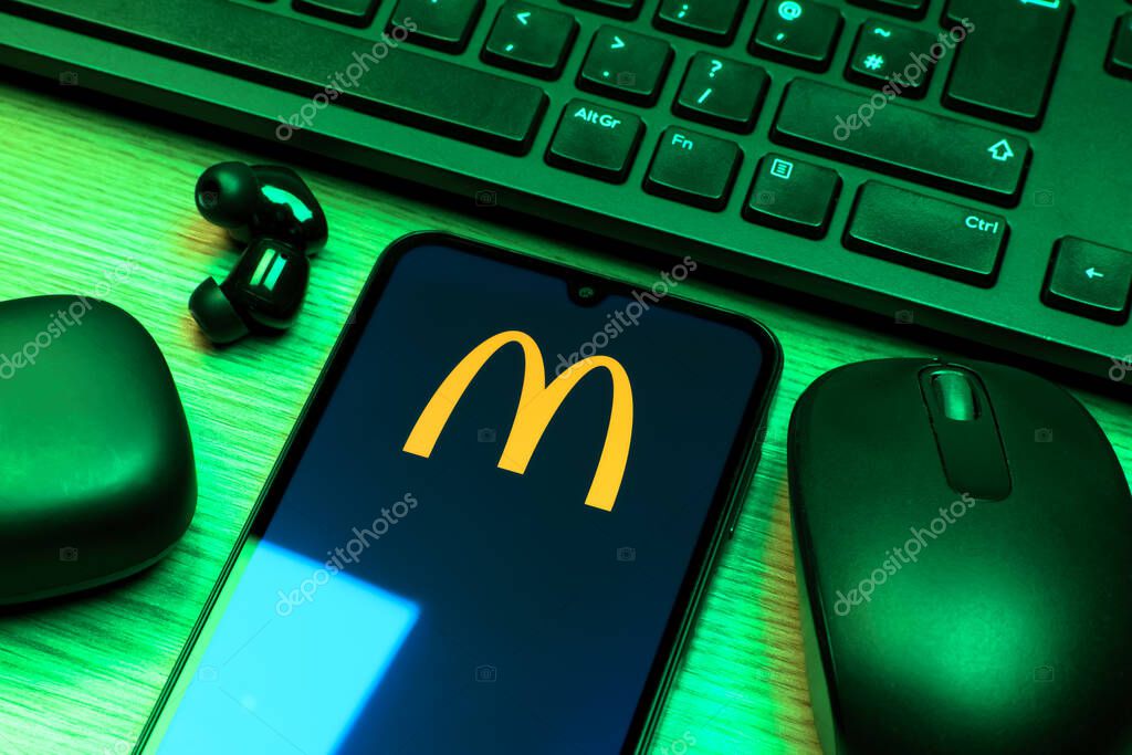Prague, Czechia - 10 21 2024: Smartphone on surface showing McDonalds logo.