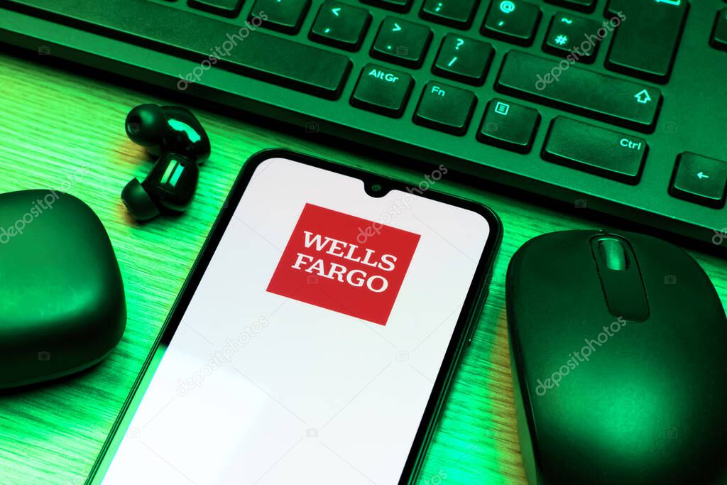 Prague, Czechia - 10 21 2024: Smartphone on surface showing Wells Fargo logo.