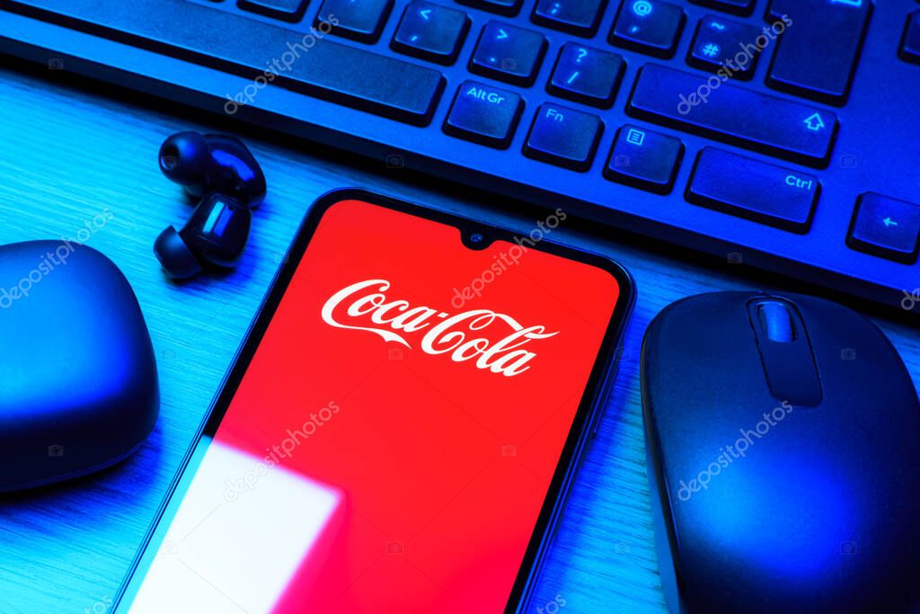Prague, Czechia - 10 21 2024: Smartphone on surface showing Coca-Cola logo.