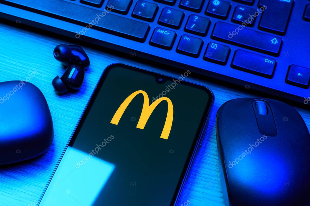 Prague, Czechia - 10 21 2024: Smartphone on surface showing McDonalds logo.