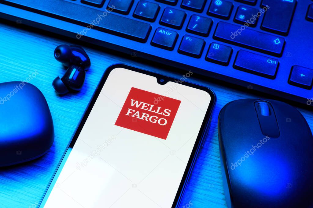 Prague, Czechia - 10 21 2024: Smartphone on surface showing Wells Fargo logo.