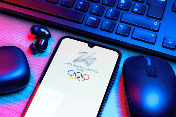 Prague, Czechia - 10 21 2024: Smartphone on surface showing Olympics Milano Cortina logo.