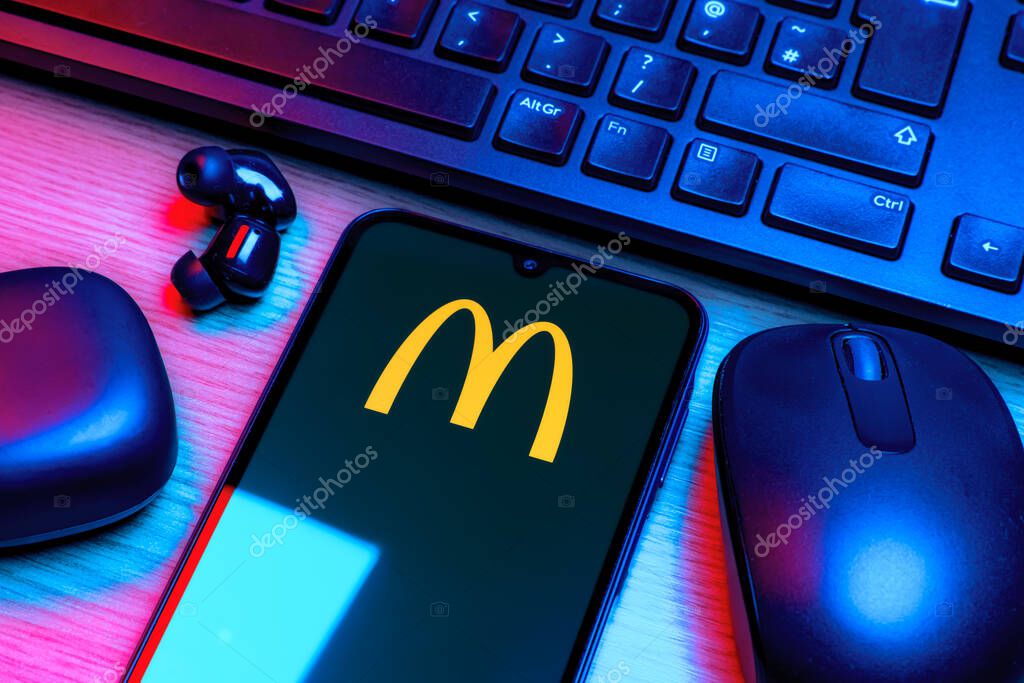 Prague, Czechia - 10 21 2024: Smartphone on surface showing McDonalds logo.