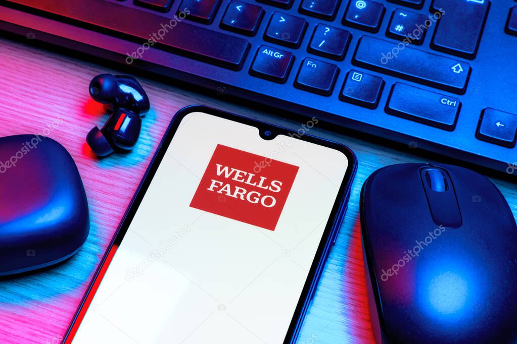 Prague, Czechia - 10 21 2024: Smartphone on surface showing Wells Fargo logo.