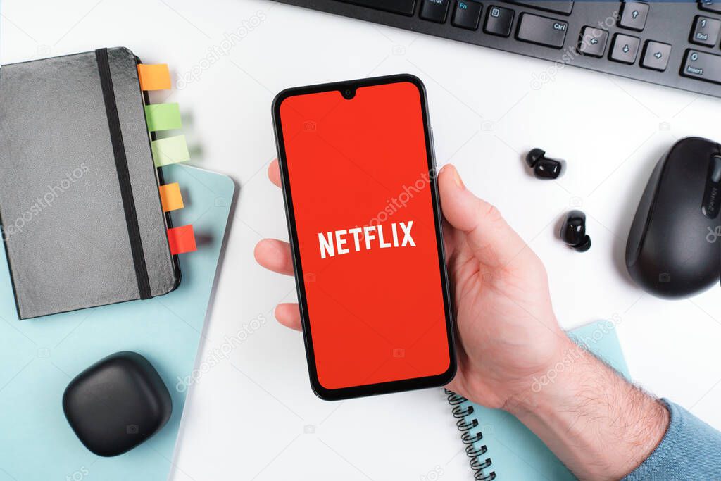 Prague, Czechia - 10 21 2024: Smartphone on surface showing Netflix logo.