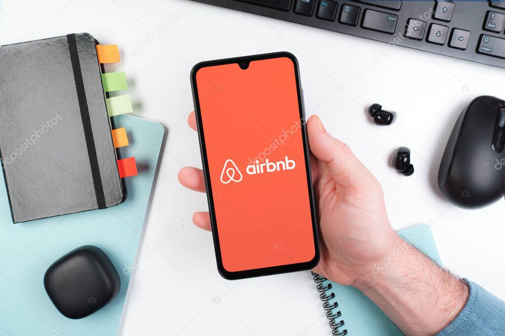 Prague, Czechia - 10 21 2024: Smartphone on surface showing Airbnb logo.