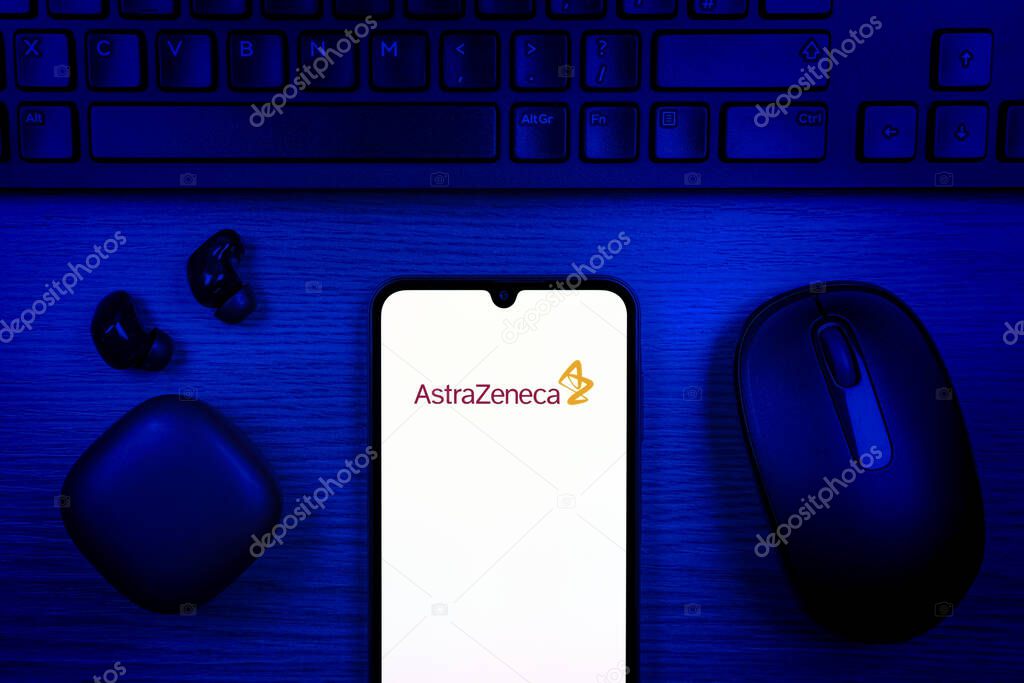 Prague, Czechia - 10 21 2024: Smartphone on surface showing AstraZeneca logo.