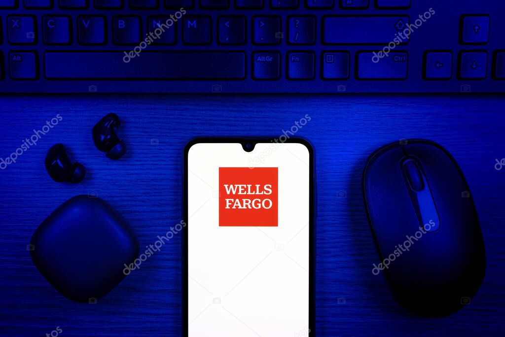 Prague, Czechia - 10 21 2024: Smartphone on surface showing Wells Fargo logo.