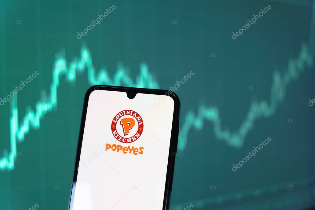 Prague, Czechia - 10 21 2024: Smartphone on surface showing Popeyes logo.