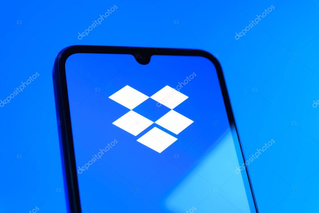 Prague, Czechia - 10 21 2024: Smartphone on surface showing Dropbox logo.