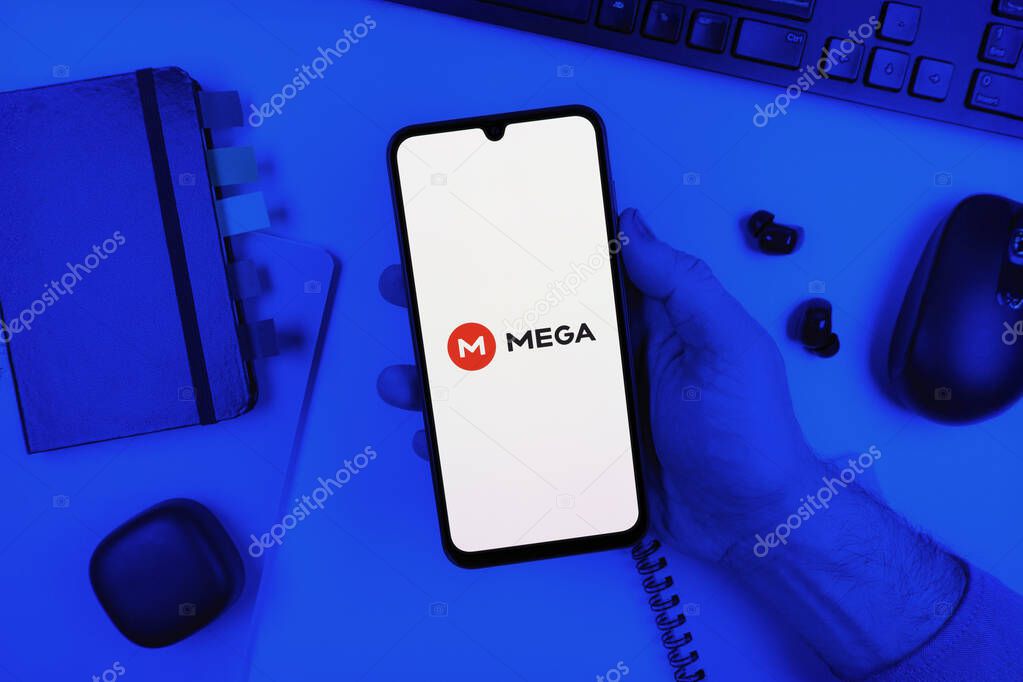 Prague, Czechia - 10 21 2024: Smartphone on surface showing Mega logo.