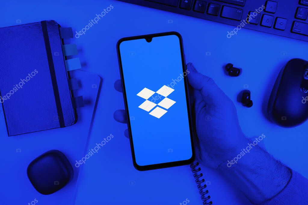 Prague, Czechia - 10 21 2024: Smartphone on surface showing Dropbox logo.
