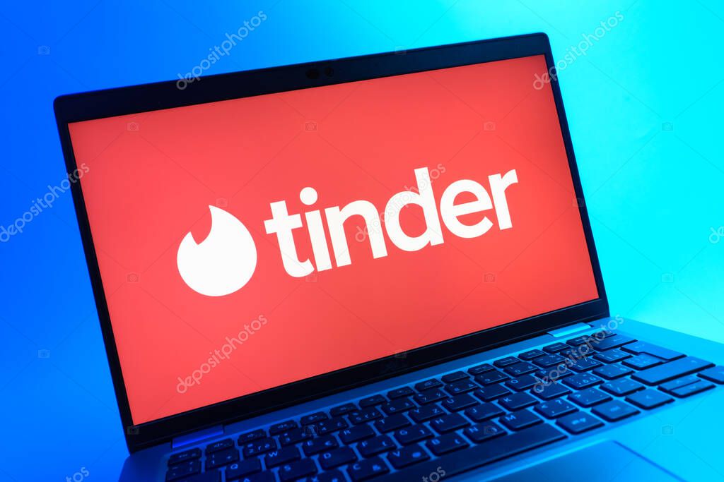 Prague, Czechia - 05 08 2025: A close-up view of a laptop lying on a colorful background, showing Tinder logo.
