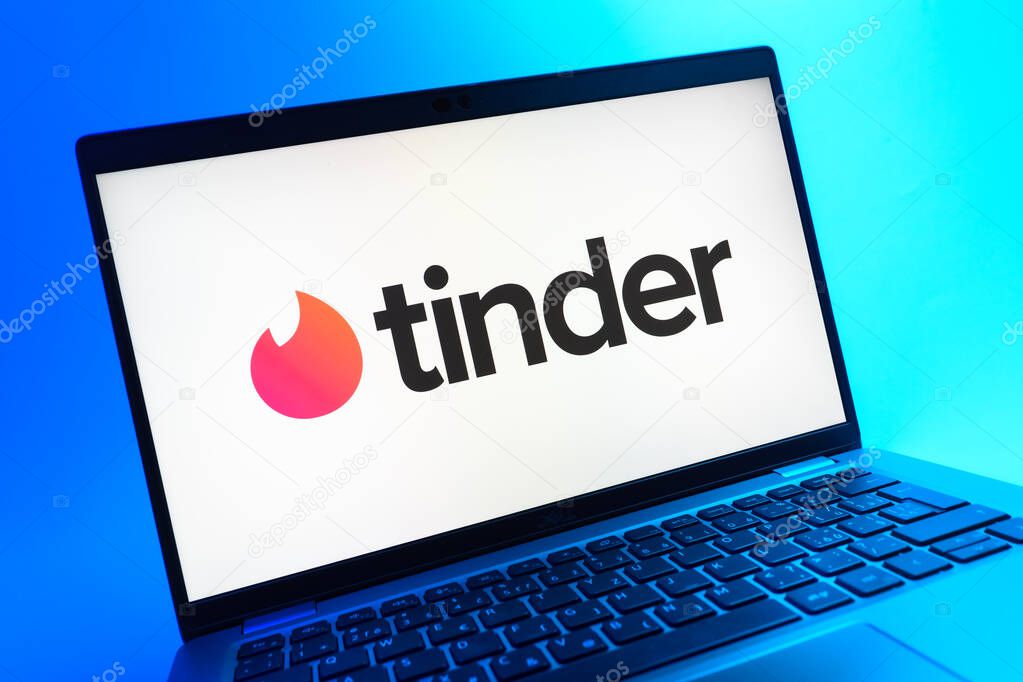 Prague, Czechia - 05 08 2025: A close-up view of a laptop lying on a colorful background, showing Tinder logo.
