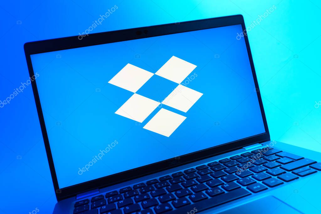 Prague, Czechia - 05 08 2025: A close-up view of a laptop lying on a colorful background, showing Dropbox logo.