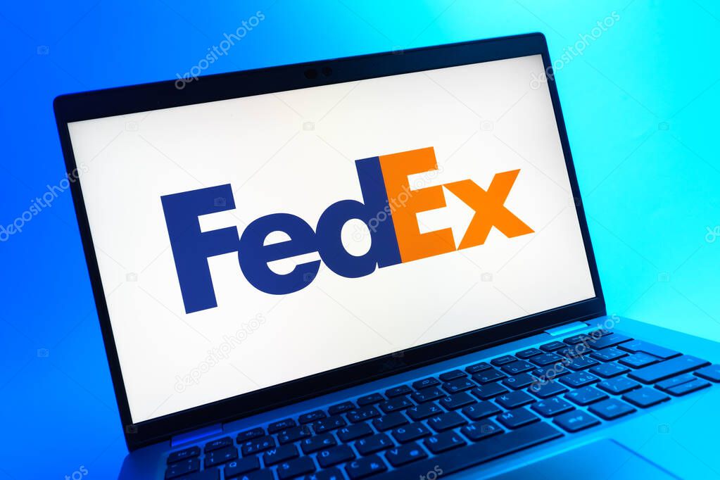Prague, Czechia - 05 08 2025: A close-up view of a laptop lying on a colorful background, showing FedEX logo.