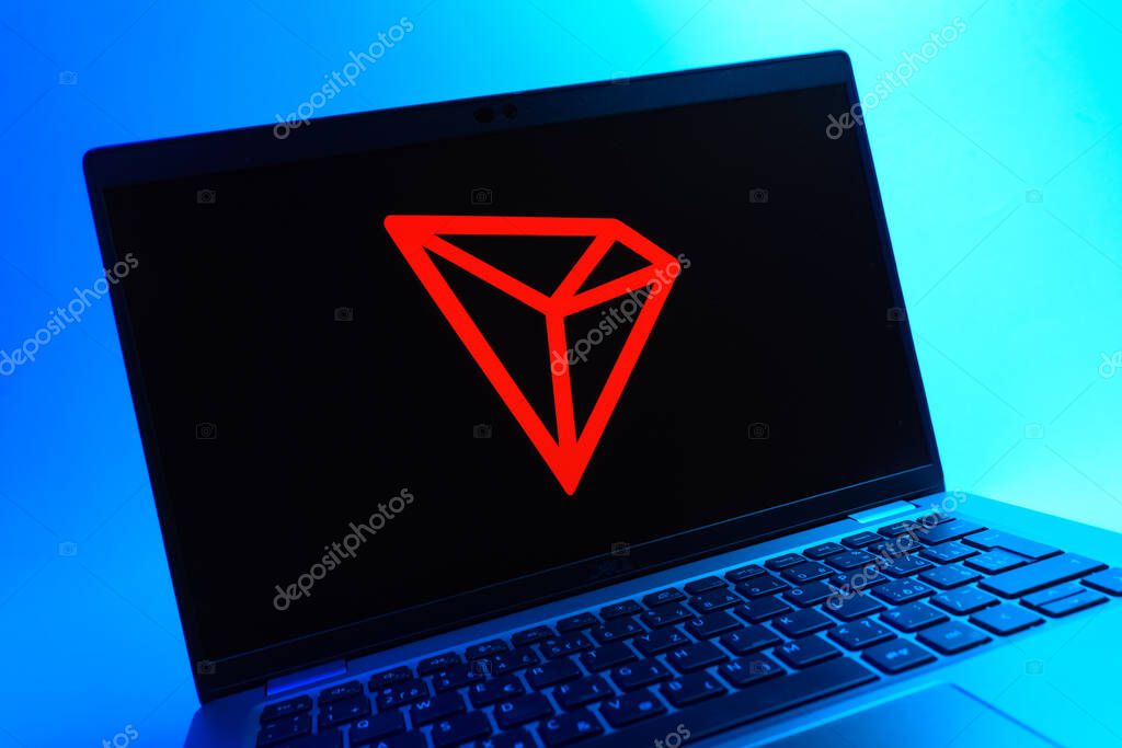 Prague, Czechia - 05 08 2025: A close-up view of a laptop lying on a colorful background, showing Tron logo.